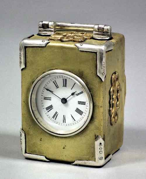 Appraisal: A late Victorian silver mounted gilt brass cased travelling timepiece