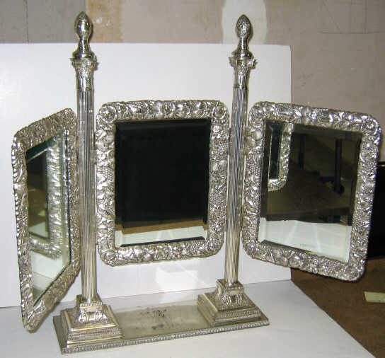 Appraisal: PLATED SILVER TRIFOLD DRESSING MIRROR Beveled edge central panel mounted