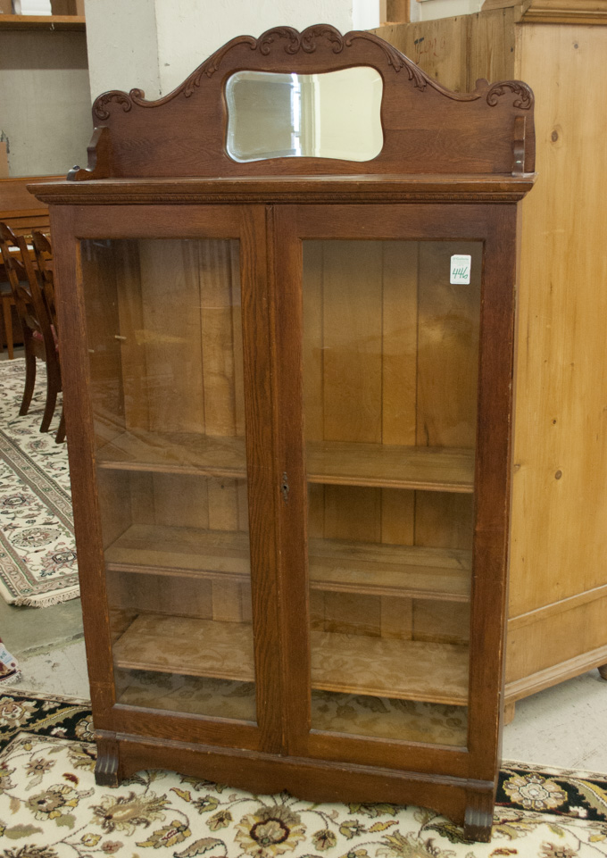 Appraisal: AN OAK CABINET BOOKCASE American c having a mirror paneled