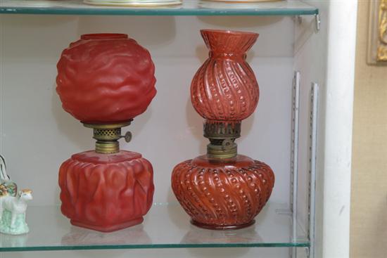 Appraisal: TWO MINIATURE RUBY GLASS OIL LAMPS WITH SHADES One molded