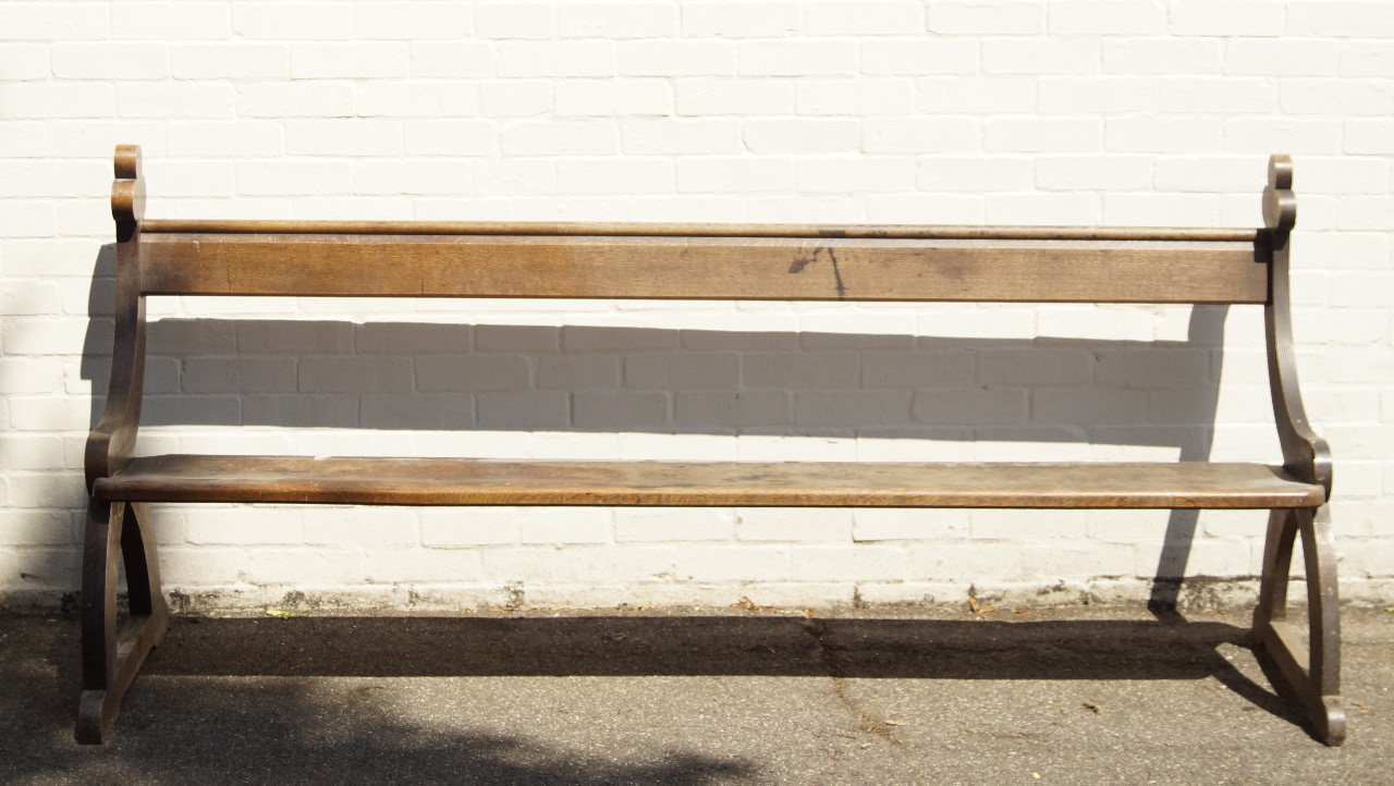 Appraisal: An oak ecclesiastical church pew having slat board seat with