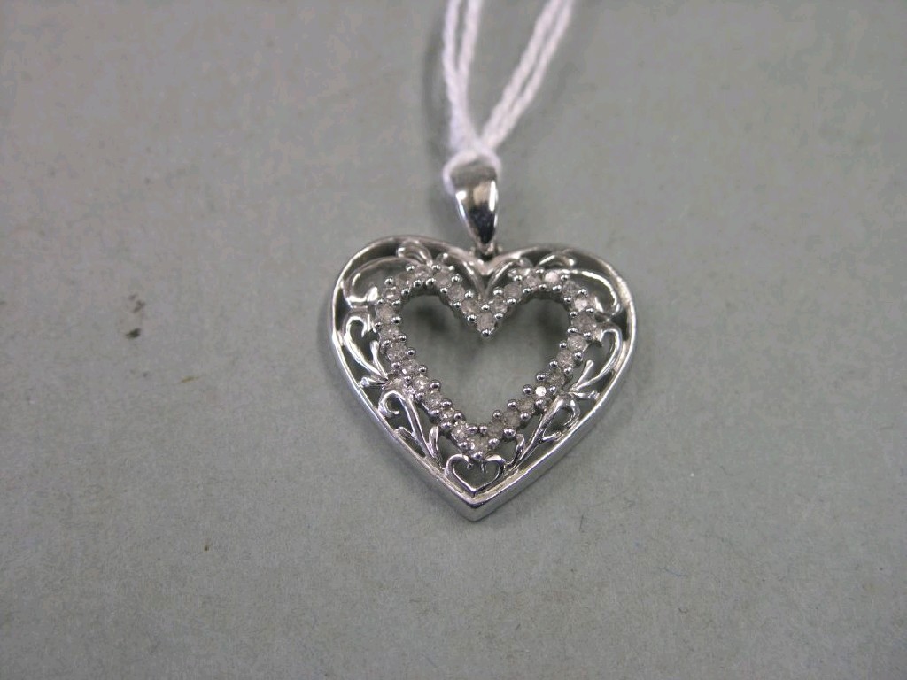 Appraisal: A white metal and diamond pendant in the form of