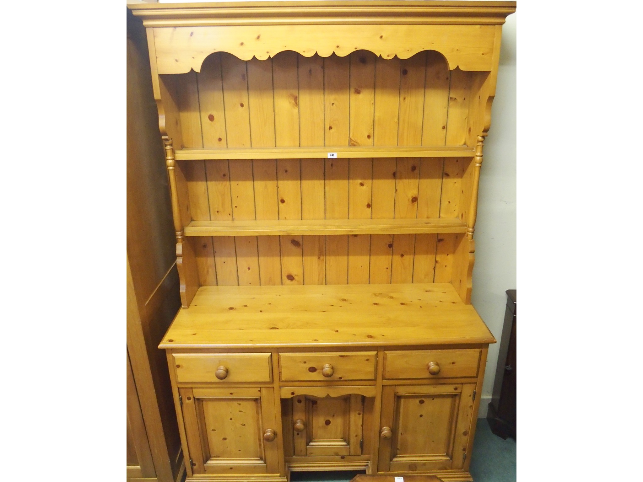 Appraisal: A contemporary pine dresser with three drawers over three cupboards