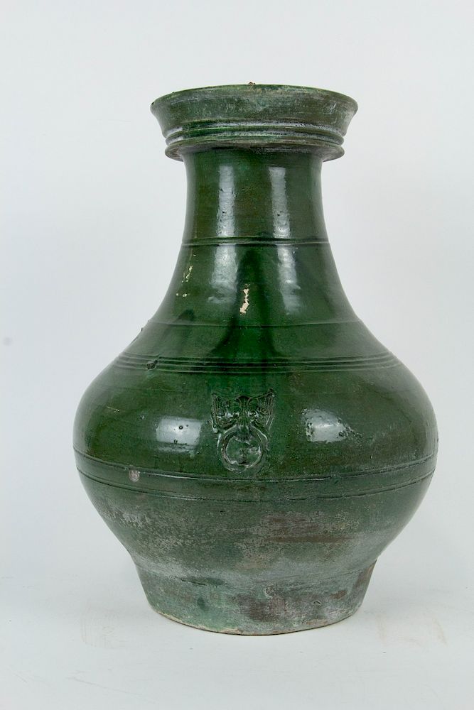 Appraisal: A Green Lead-Glazed Hu-Form Jar Chinese in the Han style