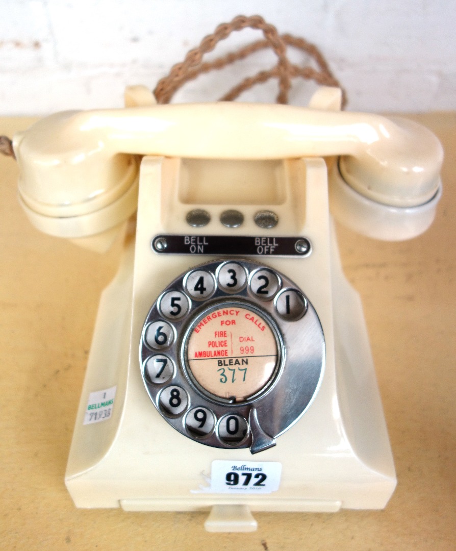 Appraisal: A f ivory coloured bakelite telephone with three button blanks