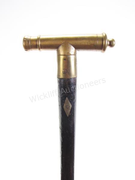 Appraisal: Brass Cannon Cane solid ebony shaft with brass inlay decoration