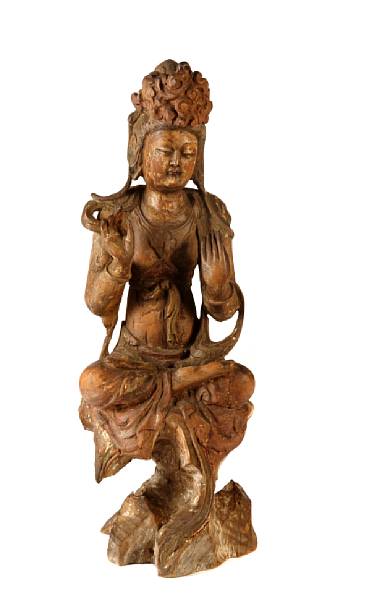 Appraisal: A Ming style carved and painted wood seated Guanyin left