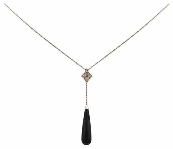 Appraisal: AN ONYX AND DIAMOND PENDANT BY JAN LOGAN Comprising a