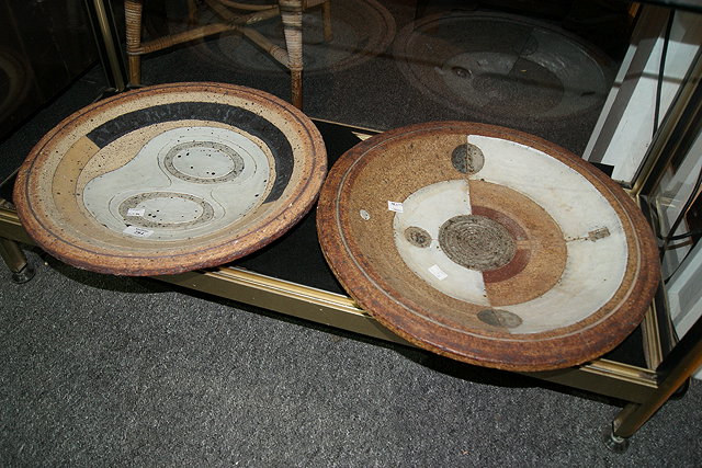 Appraisal: A PAIR OF LARGE STUDIO POTTERY CHARGERS each with abstract