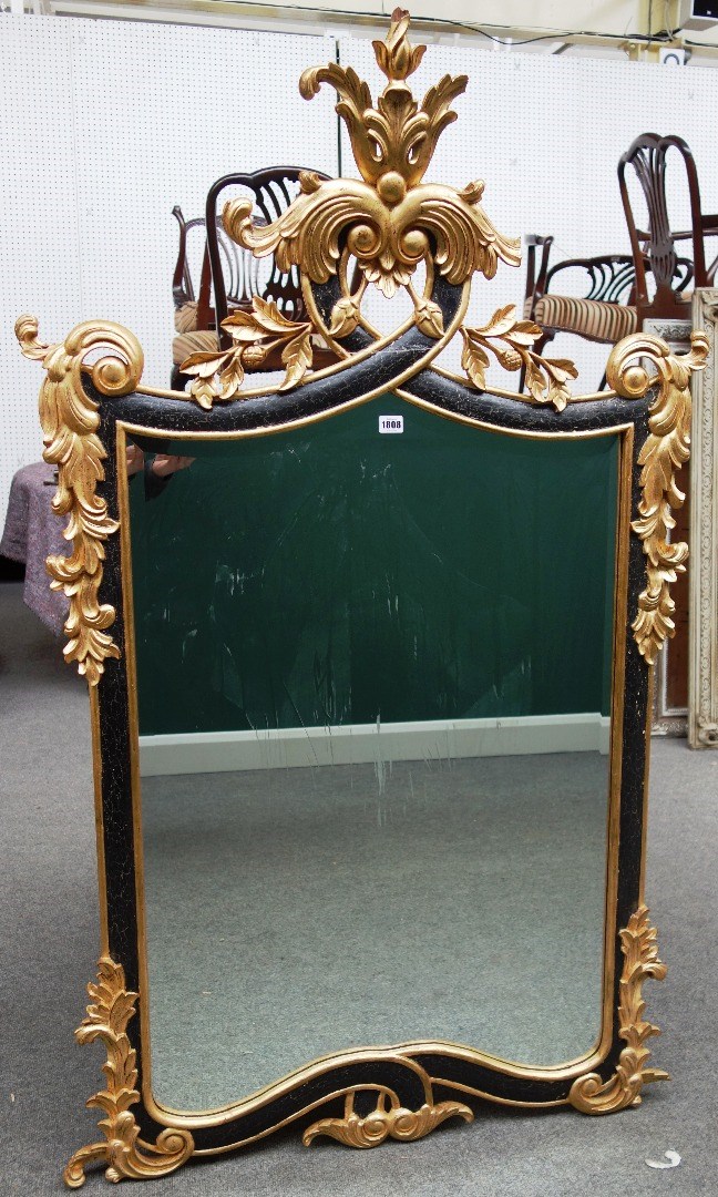 Appraisal: An th century Italian style parcel gilt ebonised wall mirror