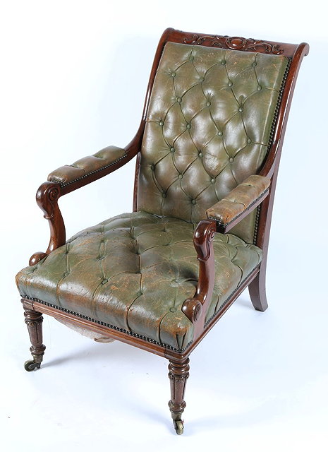 Appraisal: A TH CENTURY CARVED MAHOGANY LIBRARY ARMCHAIR upholstered in button