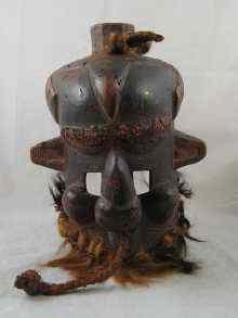 Appraisal: An African tribal helmet mask with fibre beads and animal