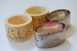 Appraisal: FOUR NAPKIN RINGS INC IVORY AND SILVER