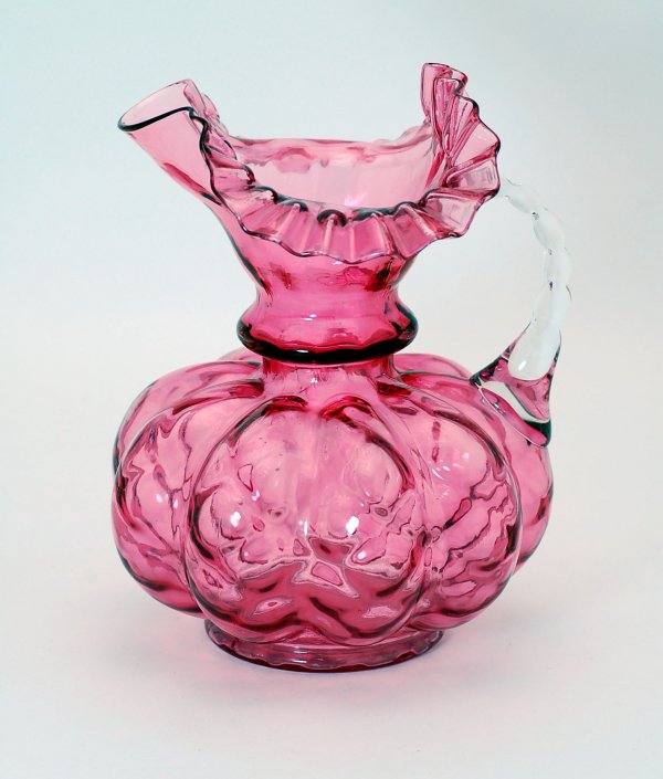 Appraisal: Fenton cranberry art glass pitcher quilted melon shaped body with