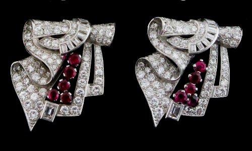 Appraisal: A ruby and diamond double-clip brooch of ribbon-scroll form each