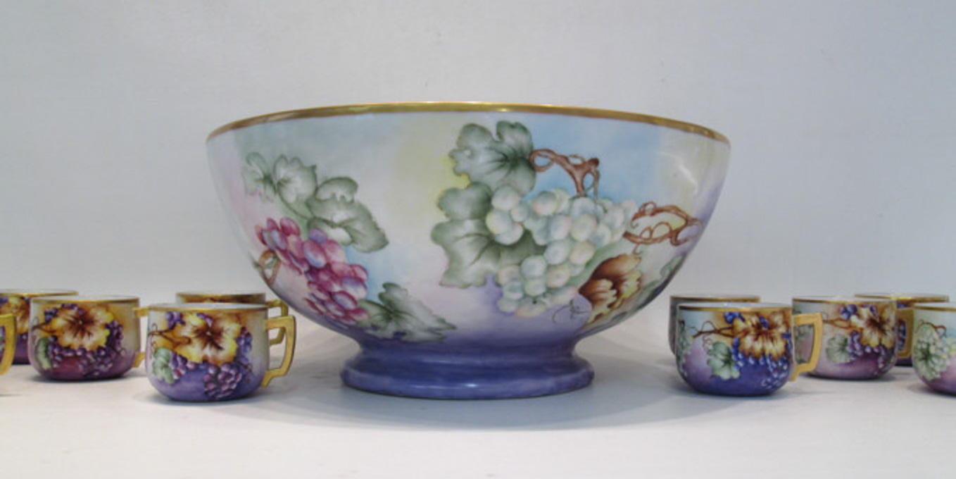 Appraisal: HAND PAINTED PORCELAIN PUNCH BOWL AND CUPS the bowl with