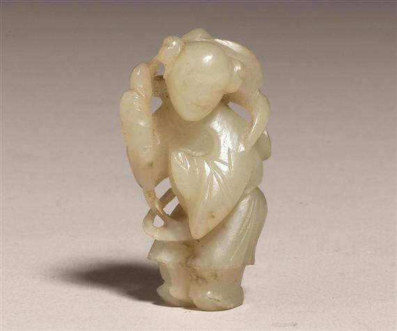 Appraisal: A SMALL CELADON JADE FIGURE OF A BOY WITH PEACHES