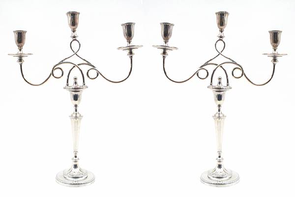 Appraisal: A George III pair of silver candlesticks with Sheffield plate