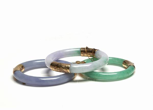 Appraisal: A group of three jade and gold bangles