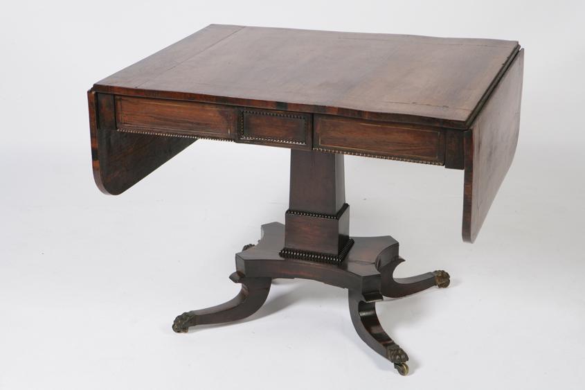 Appraisal: A REGENCY ROSEWOOD AND BRASS STRUNG SOFA TABLE the rectangular