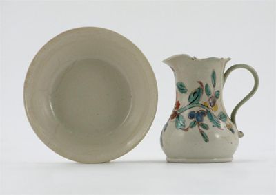 Appraisal: A Staffordshire salt-glazed cream jug painted with a polychrome spray