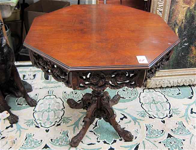 Appraisal: CARVED WALNUT LAMP TABLE American c 's having an octagonal