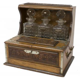 Appraisal: ARTS CRAFTS OAK TANTALUS WITH THREE DECANTERS Arts and crafts