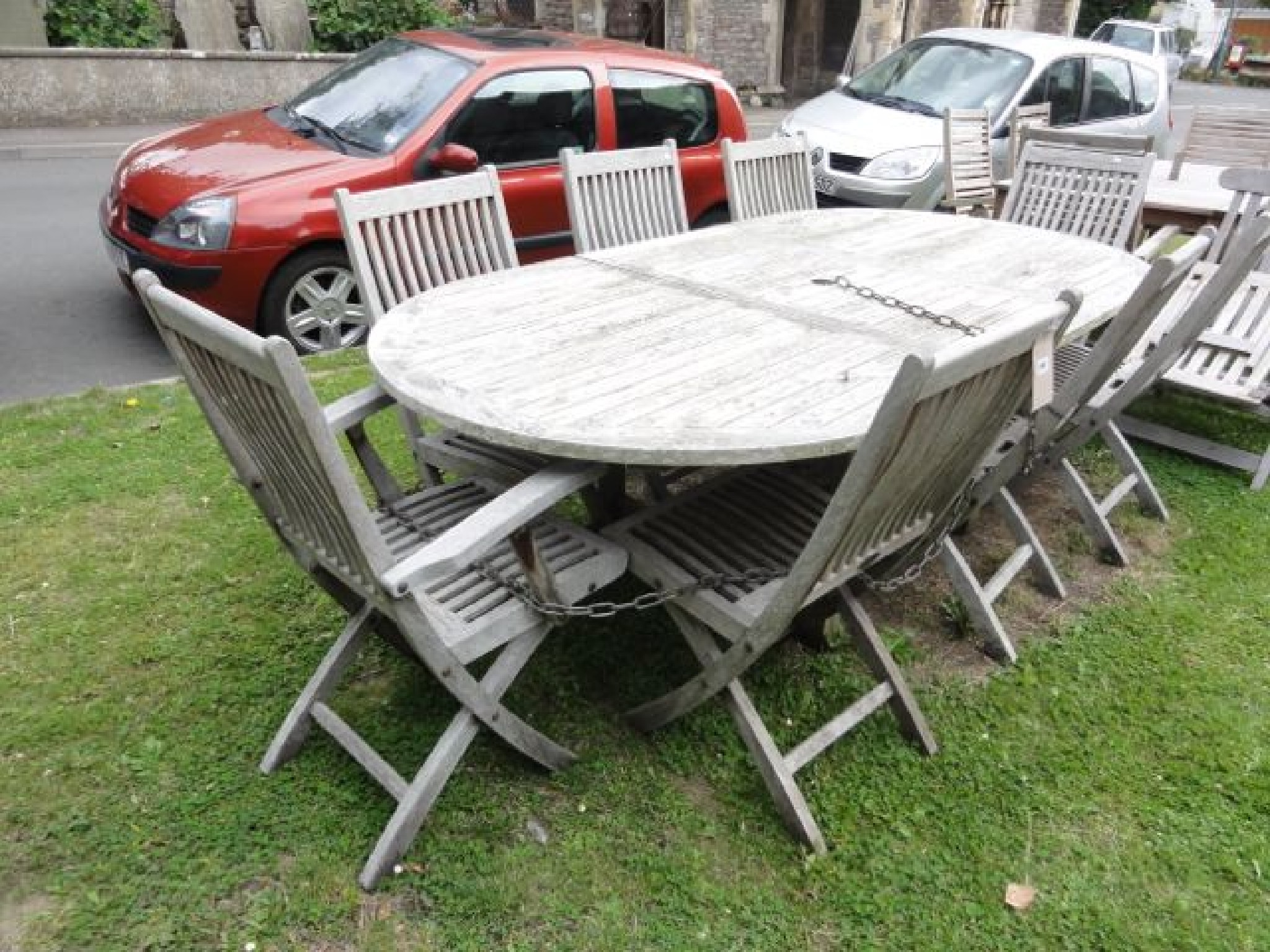 Appraisal: A weathered contemporary teak D end extending garden table the