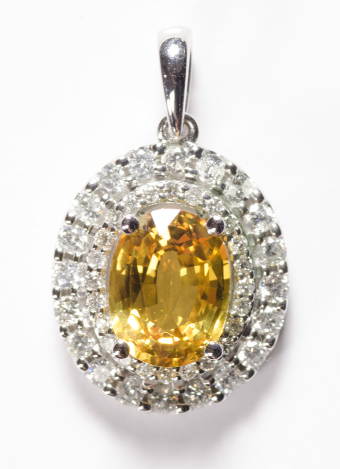 Appraisal: YELLOW SAPPHIRE DIAMOND AND FOURTEEN KARAT WHITE GOLD PENDANT an