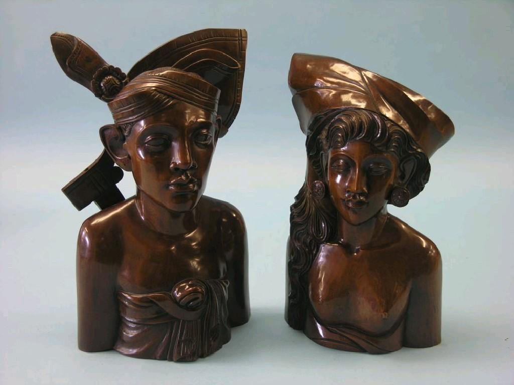 Appraisal: A pair of African carved hardwood portrait busts male and