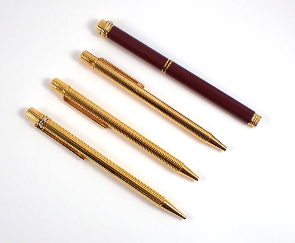 Appraisal: FOUR CARTIER PENS WITH ORIGINAL RED BOXES Must de Cartier