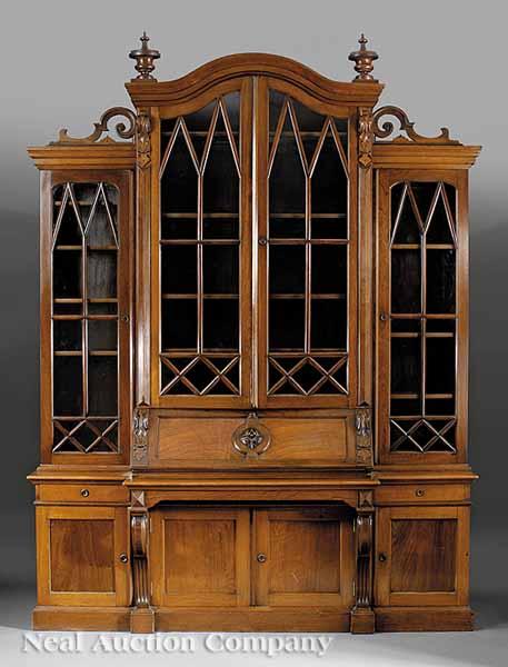 Appraisal: An American Renaissance Carved Walnut Breakfront Bookcase and Desk late