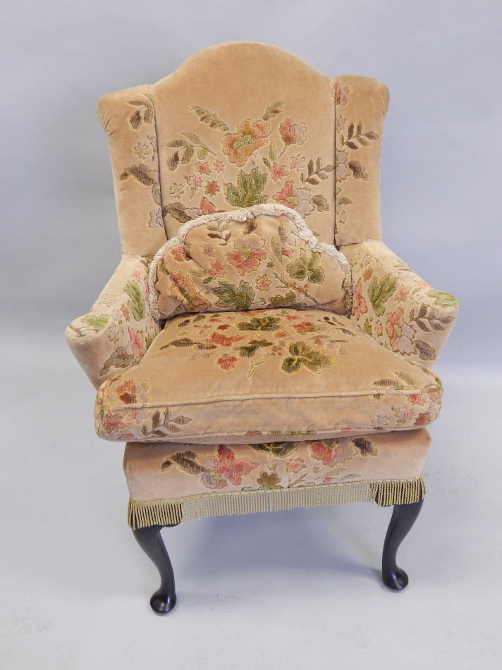 Appraisal: An early thC mahogany wingback armchair upholstered in beige velvet