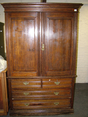 Appraisal: A late Victorian oak linen press the moulded cornice above