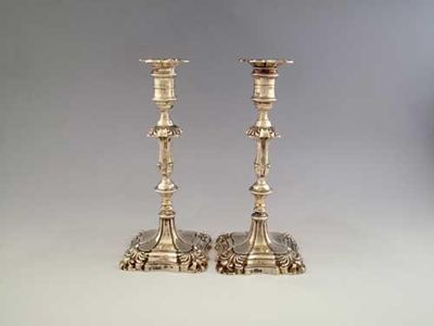 Appraisal: A pair of late Victorian candlesticks on shaped square bases