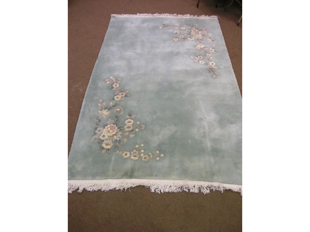 Appraisal: A Chinese wool thick pile rug opposing coloured floral designs