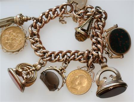 Appraisal: A large gold charm bracelet the large curb links with