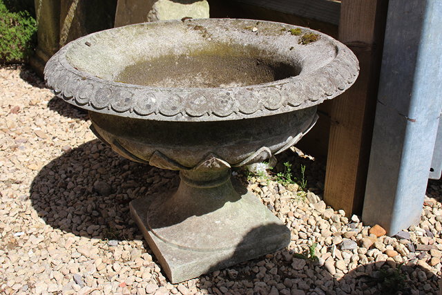 Appraisal: A COMPOSITE STONE URN OF CAMPANA FORM on a square