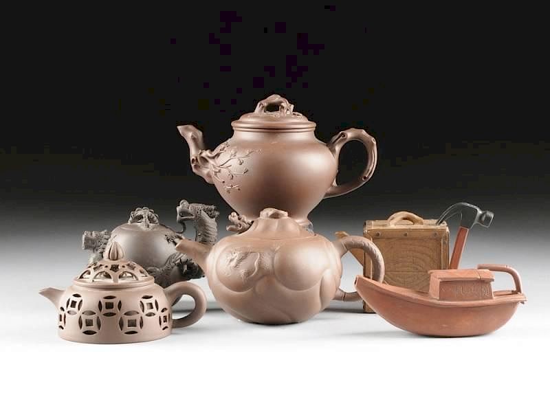 Appraisal: A GROUP OF SIX UNUSUAL YIXING EARTHENWARE TEAPOTS EACH SIGNED