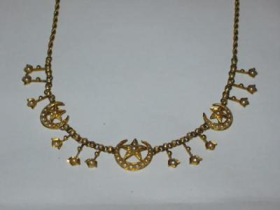 Appraisal: AN EDWARDIAN SEED PEARL NECKLACE comprising pearl set moon and