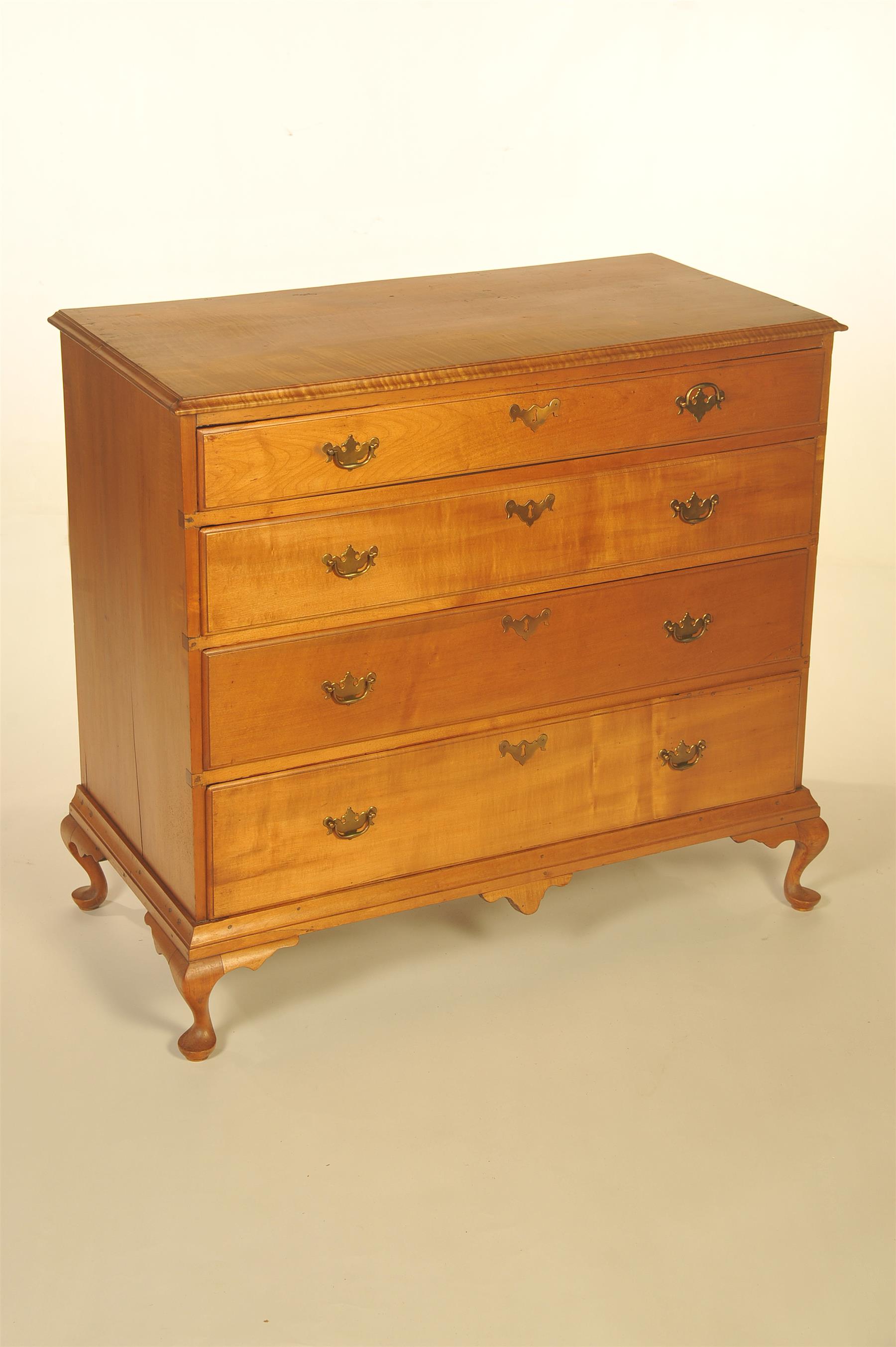 Appraisal: TIGER MAPLE FOUR-DRAWER CHEST American ca Routed top edge solid