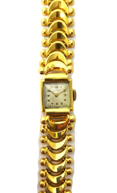 Appraisal: A lady's gold shaped square cased wristwatch the rectangular silvered