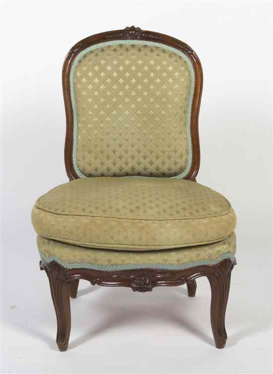 Appraisal: A French Provincial Walnut Slipper Chair having a foliate carved