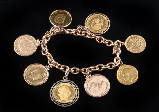 Appraisal: YELLOW GOLD FLEXIBLE LINK COIN BRACELET Oval links completed by