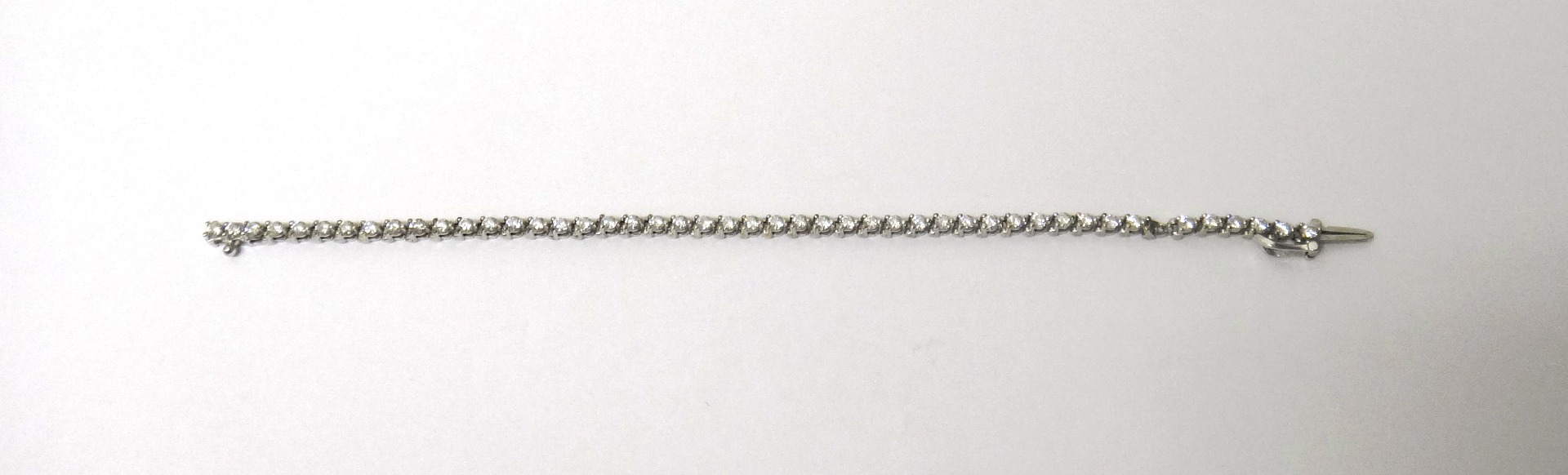 Appraisal: A white gold and diamond set line bracelet claw set