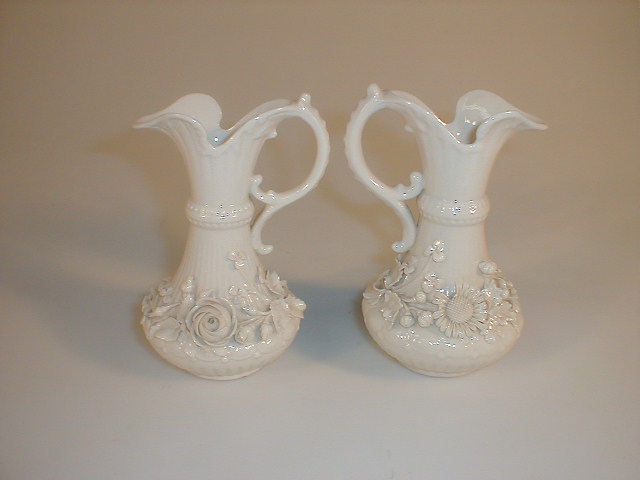 Appraisal: A pair of Belleek jugs of swept bellied form scroll