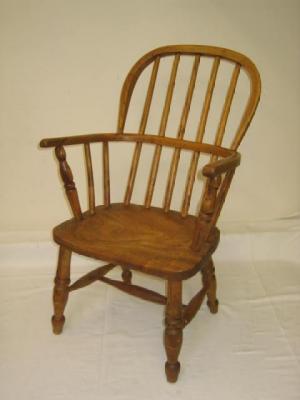 Appraisal: A CHILD'S ASH AND ELM WINDSOR ARMCHAIR of high hooped