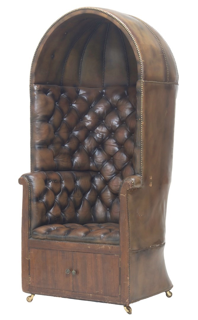 Appraisal: A brass studded brown leather porter's chair with full canopy