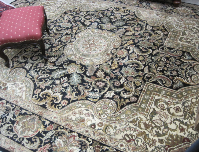 Appraisal: HAND KNOTTED ORIENTAL CARPET Indo-Persian floral and central floral lozenge