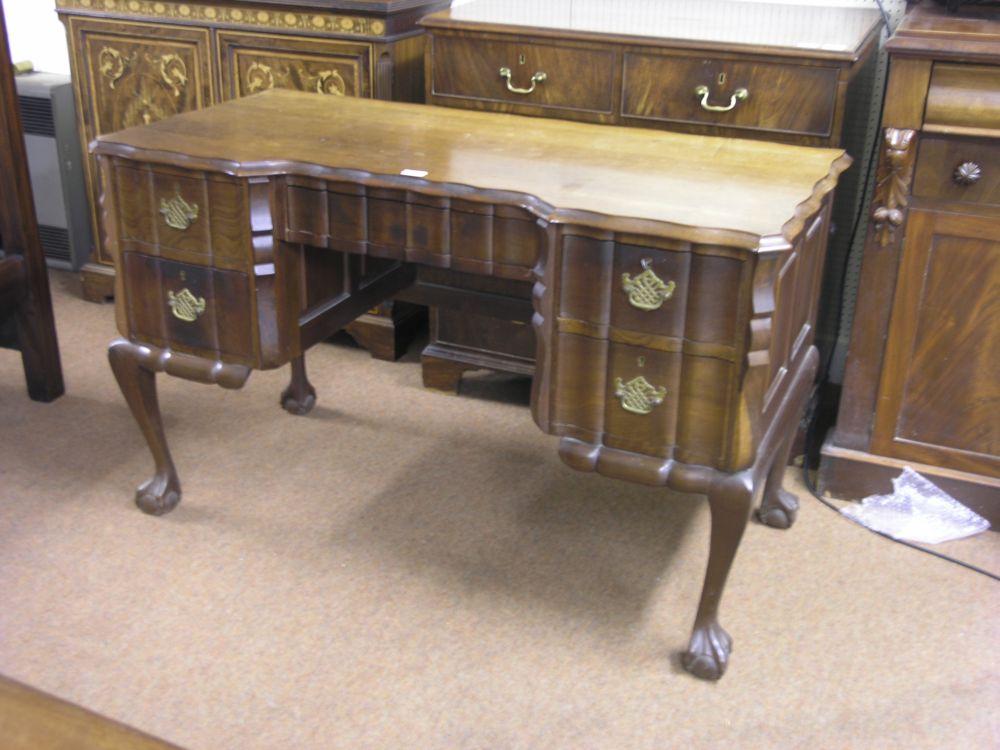 Appraisal: A hardwood colonial style writing desk block fronted form with